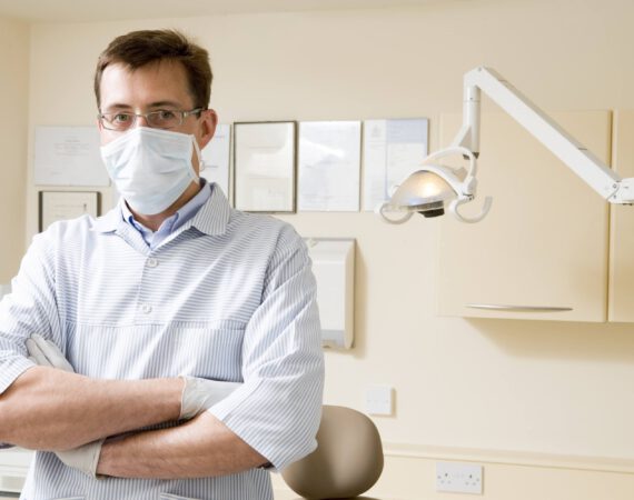 Dentist in exam room with mask on